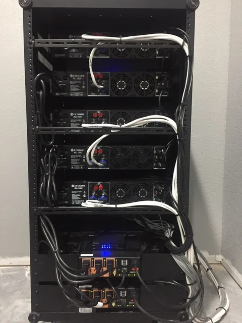 Rear of the Gethsemane sanctuary audio rack with routed signal and loudspeaker cabling