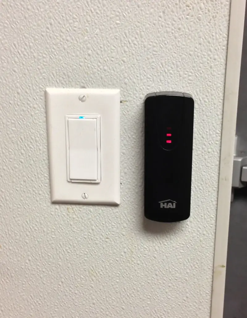 HAI access-control reader beside a lighting control