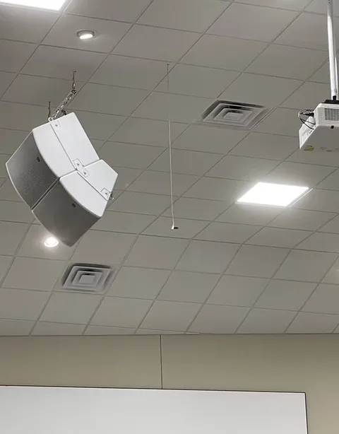Flown Maple Springs main loudspeaker and subwoofer array with a laser projector behind it